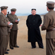 North Korean dictator Kim Jong Un (center) talks with military advisors in a photo released by the NK government